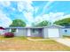 Charming single-story home with gray exterior, attached garage, and well-maintained front yard at 9850 Richwood Ln, Port Richey, FL 34668