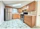 Kitchen featuring stainless steel appliances, wood cabinets, and tile backsplash at 9850 Richwood Ln, Port Richey, FL 34668