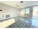Bright living room with tile flooring and a ceiling fan at 9850 Richwood Ln, Port Richey, FL 34668