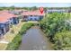 Aerial view of condo buildings featuring a canal behind the property at 9970 Eagles Point Cir # 3, Port Richey, FL 34668