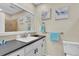 Bathroom vanity with a modern sink, dark countertop, and light blue accents and sea turtle decorations at 9970 Eagles Point Cir # 3, Port Richey, FL 34668