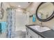 Bright bathroom with a white vanity, shower/tub combo, and charming nautical themed decor at 9970 Eagles Point Cir # 3, Port Richey, FL 34668