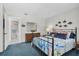 Cozy bedroom with unique fish decorations, dresser with mirror, and blue carpet at 9970 Eagles Point Cir # 3, Port Richey, FL 34668