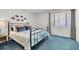 Bedroom with black metal bed frame, colorful pillows and comforter, and window with blinds at 9970 Eagles Point Cir # 3, Port Richey, FL 34668