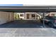 Carport view with vehicle parked underneath at 9970 Eagles Point Cir # 3, Port Richey, FL 34668