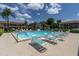 Inviting community pool with lounge chairs, creating a relaxing and social atmosphere for residents at 9970 Eagles Point Cir # 3, Port Richey, FL 34668