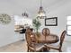 Dining room next to the kitchen, brightened by natural light and stylish pendant lighting at 9970 Eagles Point Cir # 3, Port Richey, FL 34668