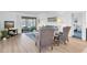 Open-concept living room with sliding glass doors to a screened patio and neutral décor for relaxation at 9970 Eagles Point Cir # 3, Port Richey, FL 34668