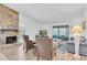 Inviting living room with stone fireplace, comfortable seating, and sliding glass doors to the outdoors at 9970 Eagles Point Cir # 3, Port Richey, FL 34668