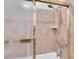 Shower features sliding glass door, tiled walls, overhead shower head, and hand rails at 9970 Eagles Point Cir # 3, Port Richey, FL 34668