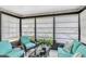Bright sunroom featuring lots of windows, tile flooring, and comfortable seating at 9970 Eagles Point Cir # 3, Port Richey, FL 34668