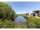 A picturesque view of the waterway, framed by lush greenery, highlighting the waterfront location at 9970 Eagles Point Cir # 3, Port Richey, FL 34668
