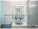 Charming bathroom with blue accents, tiled walls, and a functional shower-tub combo at 10309 Honeysuckle Ln, Port Richey, FL 34668