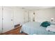Spacious bedroom with wood-look floors and ample closet space, offering comfort and functionality at 10309 Honeysuckle Ln, Port Richey, FL 34668