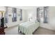 Bright bedroom featuring ample natural light from two windows with blue patterned curtains at 10309 Honeysuckle Ln, Port Richey, FL 34668