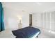 Well-lit bedroom with a single bed, closet, and neutral walls providing a serene atmosphere at 10309 Honeysuckle Ln, Port Richey, FL 34668