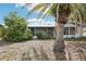 Charming home exterior surrounded by mature landscaping, creating a private oasis at 10309 Honeysuckle Ln, Port Richey, FL 34668