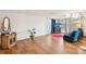 Bright living room with wood-look floors, large windows, comfortable seating, and stylish decor creating a welcoming space at 10309 Honeysuckle Ln, Port Richey, FL 34668