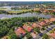 Beautiful aerial view of a residential community with lush landscaping, a lake, and a golf course at 1033 Tuscany Dr, Trinity, FL 34655