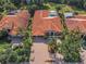 Beautiful home with well-manicured landscaping, brick driveway and screened in pool in aerial view at 1033 Tuscany Dr, Trinity, FL 34655