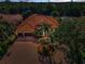 Expansive aerial view of home showcasing the brick paved driveway and tropical landscaping at 1033 Tuscany Dr, Trinity, FL 34655