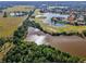 Stunning aerial view of community featuring mature trees, a lake, and a golf course at 1033 Tuscany Dr, Trinity, FL 34655