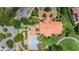 Aerial view shows the community pool, clubhouse and surrounding grounds with beautiful landscaping at 1033 Tuscany Dr, Trinity, FL 34655