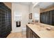 A bathroom with a shower and tub combination, a single sink vanity, and tan tile floors at 1033 Tuscany Dr, Trinity, FL 34655