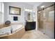 Bathroom with double vanities, a soaking tub, and a shower at 1033 Tuscany Dr, Trinity, FL 34655