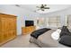 Spacious bedroom with wood furniture, soft carpet, neutral walls, and a ceiling fan at 1033 Tuscany Dr, Trinity, FL 34655
