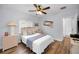 A bedroom with a wood floor, a ceiling fan, a bed, and neutral color decor at 1033 Tuscany Dr, Trinity, FL 34655