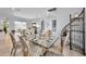Dining room with seating for six and glass table is brightly lit and airy at 1033 Tuscany Dr, Trinity, FL 34655