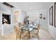 Formal dining room with seating for six features a glass table and decorative chairs at 1033 Tuscany Dr, Trinity, FL 34655