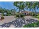 Inviting home featuring a circular driveway, mature trees, and well-maintained landscaping at 1033 Tuscany Dr, Trinity, FL 34655