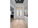 Bright foyer features decorative glass double doors, transom windows and tile flooring at 1033 Tuscany Dr, Trinity, FL 34655