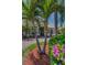 Charming home featuring lush landscaping with palm trees and seasonal flowers and double door entrance at 1033 Tuscany Dr, Trinity, FL 34655