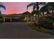 Charming home with a three car garage, brick paved driveway, and lush tropical landscaping at 1033 Tuscany Dr, Trinity, FL 34655