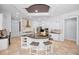 Gourmet kitchen features center island with cooktop and seating, stainless appliances, and custom cabinetry at 1033 Tuscany Dr, Trinity, FL 34655