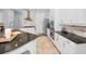 Modern kitchen showcasing white cabinetry, granite countertops, and stainless steel appliances at 1033 Tuscany Dr, Trinity, FL 34655