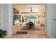 Enclosed lanai boasts a dining area and seating, with views of the pool and backyard at 1033 Tuscany Dr, Trinity, FL 34655