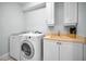 A laundry room with a washer and dryer, and a utility sink and cabinets at 1033 Tuscany Dr, Trinity, FL 34655