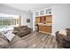 Living room with a wet bar, wood floors, a view of the pool, and comfortable seating at 1033 Tuscany Dr, Trinity, FL 34655