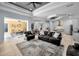 Open layout living area featuring modern furniture, seamlessly connected to an outdoor dining space and kitchen at 1033 Tuscany Dr, Trinity, FL 34655