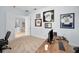 A home office with sports memorabilia, a door leading to the hall, and a wood desk at 1033 Tuscany Dr, Trinity, FL 34655