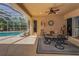 The outdoor patio boasts a fan, stylish furniture, and seamless access to the screened-in pool area at 1033 Tuscany Dr, Trinity, FL 34655