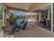 Screened patio with stone fireplace, comfortable seating, and seamless transition to indoor living at 1033 Tuscany Dr, Trinity, FL 34655