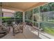 Relaxing screened patio with comfortable seating and view to the manicured yard at 1033 Tuscany Dr, Trinity, FL 34655