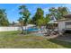 Spacious backyard featuring a pool, lounge area, and gazebo perfect for outdoor entertaining and relaxation at 11137 Addison St, Spring Hill, FL 34609
