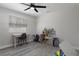Bedroom featuring a ceiling fan, window with blinds, and play furniture at 11137 Addison St, Spring Hill, FL 34609