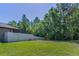 Spacious backyard featuring a lush lawn and privacy fence backing to trees, offering a serene outdoor space at 12800 Solola Way, Trinity, FL 34655
